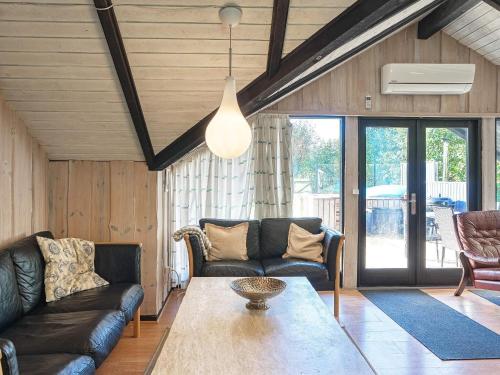 a living room with two leather couches and a table at 5 person holiday home in Dannemare-By Traum in Dannemare