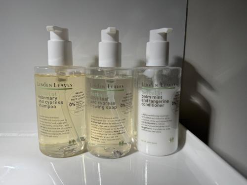 three bottles of moisturizers sitting on top of a counter at Walnut Creek Studio in West Melton