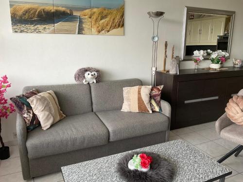 a living room with a couch and a table at Micheline's plekje in Ostend