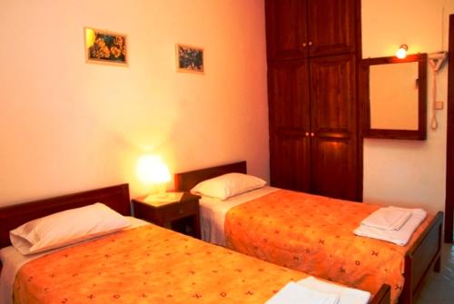 A bed or beds in a room at Kalives Apartments