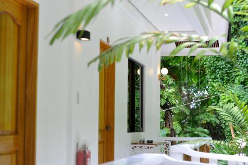 a room with a table and a window with plants at Cocoloco Beach Resort in Boracay