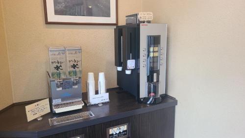 a coffee maker on a counter in a room at Uozu Manten Hotel Ekimae in Uozu
