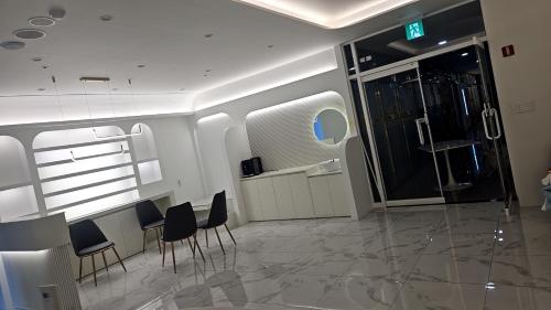 a room with chairs and a bar in a plane at Daegu Star B&B DSR Hotel lily in Daegu