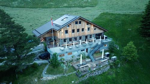 an overhead view of a large house with a flag at Berggasthaus Eggberge - Boutique Mountain Hotel - Access via Cablecar in Altdorf