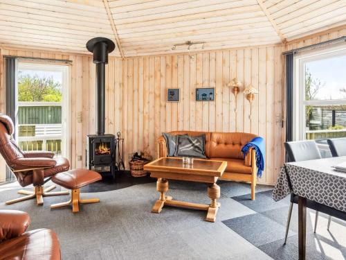 a living room with a couch and a stove at 4 person holiday home in Vinderup-By Traum in Vinderup