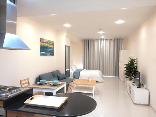 a living room with a couch and a table at Quickstay holiday homes Stylish Studio Silicon Oasis-124 in Dubai