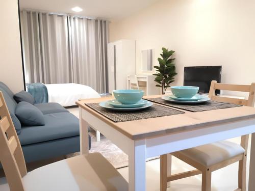 a dining room table with two blue bowls on it at Quickstay holiday homes Stylish Studio Silicon Oasis-124 in Dubai