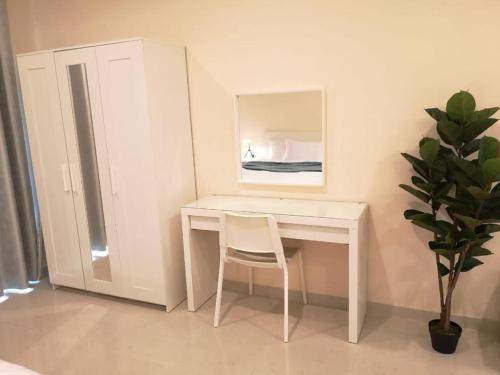 a white desk with a chair and a mirror at Quickstay holiday homes Stylish Studio Silicon Oasis-124 in Dubai