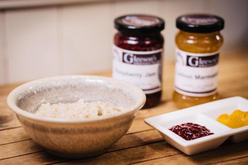 a bowl of rice and two jars of jam on a table at Gleeson's Restaurant & Rooms in Roscommon