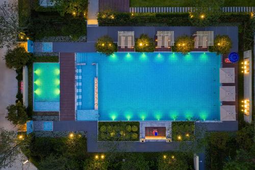 an overhead view of a swimming pool at night at Zhangjiajie SANHE Hotel --Free one way pick up service over 2 night, Free shuttle to east gate of forest park,Free laundry service,Free fresh coffee,English speaking customer service in Zhangjiajie