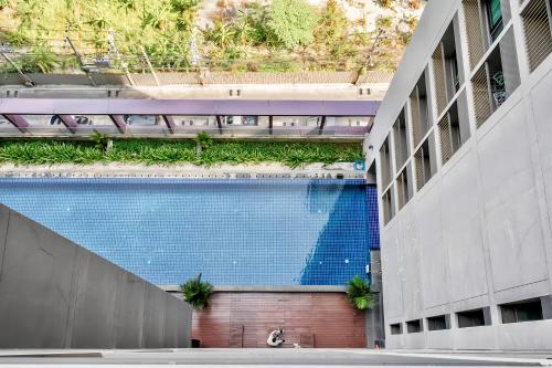 a building with a swimming pool with plants on it at Noble Remix Bangkok in Bangkok