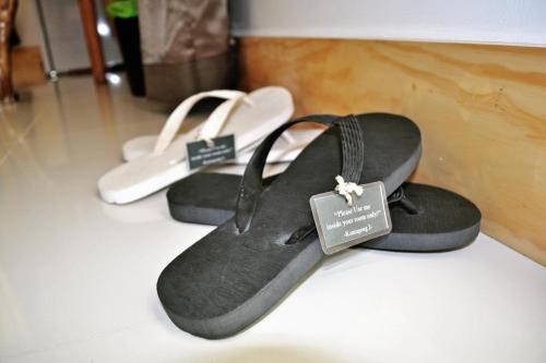a pair of black sandals with a price tag on them at Cocoloco Beach Resort in Boracay