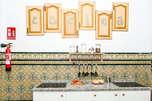 a kitchen with tiles on the wall and a counter at Onefam Catedral in Seville