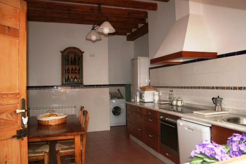 a kitchen with a sink and a washing machine at La Casona de Mahora in Mahora