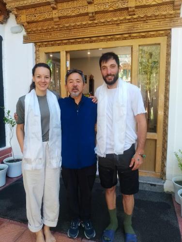 two men and a woman posing for a picture at Rock Castle Residency in Leh