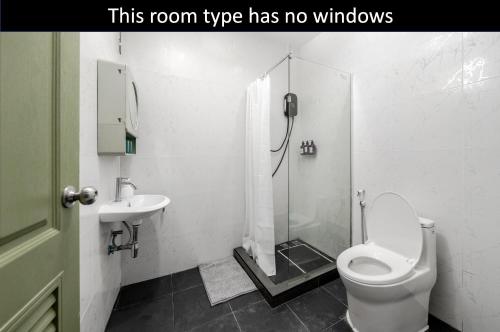 a bathroom with a shower and a toilet and a sink at Blue House 191 Hometel in Chinatown