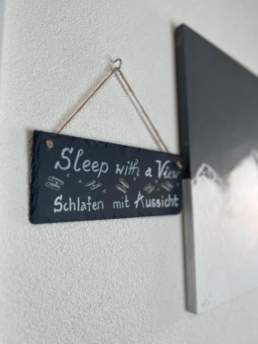 a sign that says sleep with a year in sittinian muskrit at Berggasthaus Eggberge - Boutique Mountain Hotel - Access via Cablecar in Altdorf