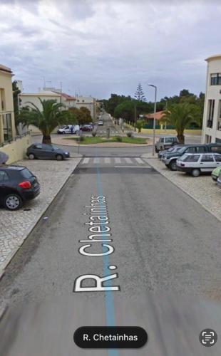 a street with cars parked in a parking lot at Cascais - Villa at Guincho Beach in Charneca