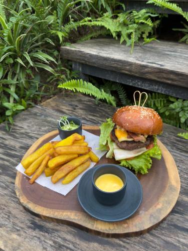 a plate of food with a hamburger and french fries at AMAYA HOME - Lodge, Spa & Restaurant in Hanoi