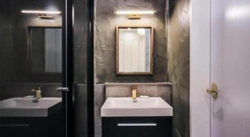 a bathroom with two sinks and a mirror at Hotel Seowa in Gimhae
