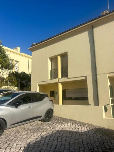a white car parked in front of a house at Cascais - Villa at Guincho Beach in Charneca