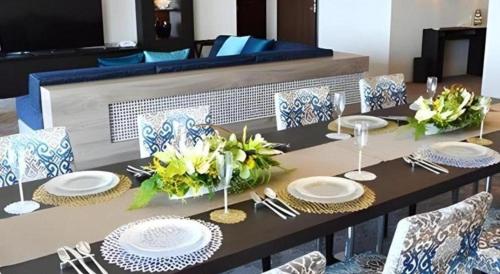 a table with plates and flowers on top of it at Hotel Harvest Nankitanabe in Tanabe