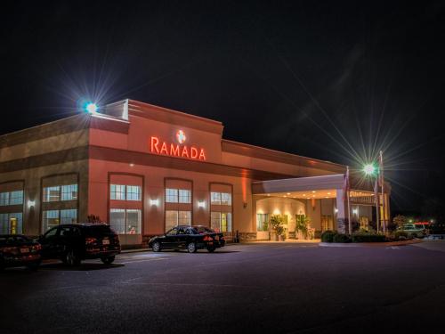 a rambala store at night with cars parked in front at Ramada by Wyndham Trenton in Trenton