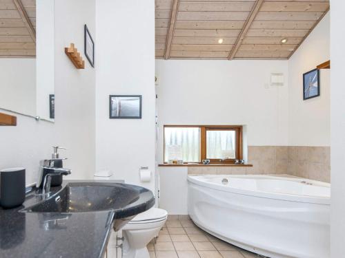 a large bathroom with a large tub and a toilet at 7 person holiday home in Ulfborg-By Traum in Thorsminde