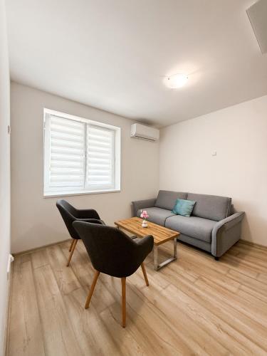a living room with a couch and a table at Apartmány na Bolzance in Znojmo