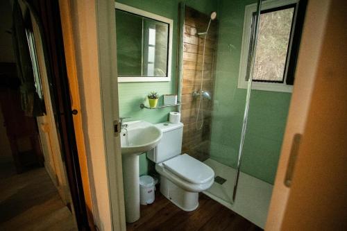 a bathroom with a toilet and a sink and a shower at Casita Verbena Retreat in Novo Sancti Petri