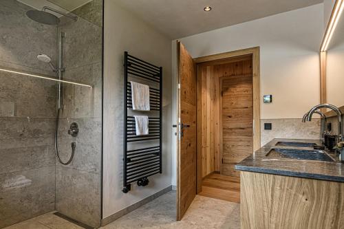 a bathroom with a shower and a sink at Naturhof eibl in Grossarl