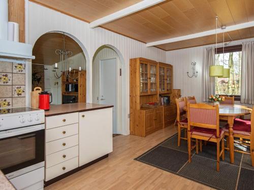 a kitchen with a table and a dining room at 6 person holiday home in Toftlund in Toftlund
