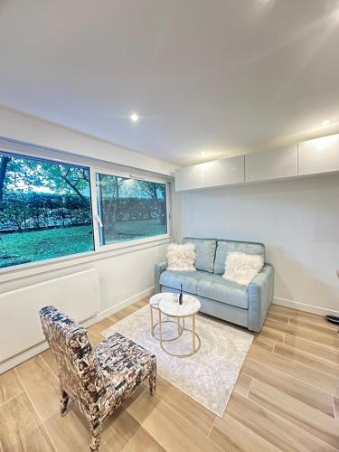 una sala de estar con un sofá y una mesa en New, modern and bright studio, en Neuilly-sur-Seine