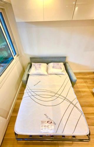 a bed in a small room in a tiny house at New, modern and bright studio in Neuilly-sur-Seine