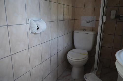a bathroom with a toilet and a roll of toilet paper at Aquasalis in Câmpulung Moldovenesc