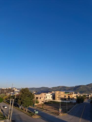 a view of a street with buildings in the background at Comfort & Luxury Stay In Islamabad in Islamabad