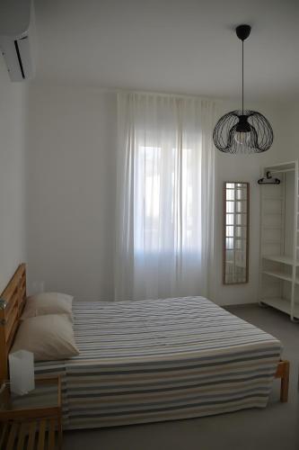 una camera da letto con un letto grande e una finestra di Appartamento 1m a Fiumaretta di Ameglia