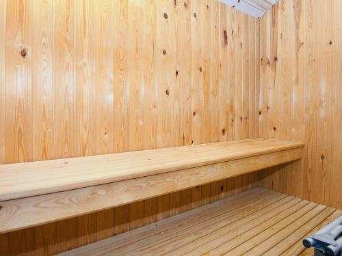 a wooden paneled sauna with a wooden bench in it at 5 star holiday home in Grenaa in Grenå