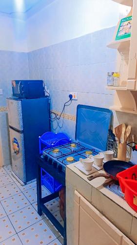 a kitchen with a stove top in a kitchen at Rozy Cozy Airbnbs South B in Nairobi