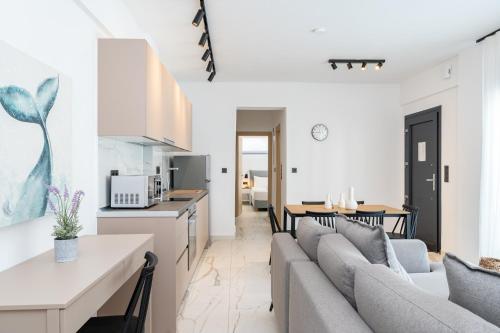 a kitchen and living room with a couch and a table at Emerald Island Residential Complex in Skala Rachoniou