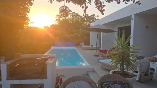 a backyard with a swimming pool and a house at NEW- Ericeira Design Villa- 10 min from Beach, pool and great view in Ericeira