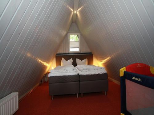 a small bedroom with a bed in a attic at Ferienhaus für 5 Personen mit Garten in Clausthal-Zellerfeld