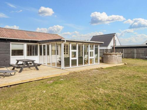 a house with a deck and a picnic table at Luxury Spa Retreat in Thorsminde - By Traum Ferienwohnungen in Ulfborg