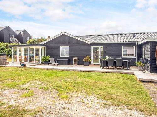 an exterior view of a house with a backyard at Luxury Spa Retreat in Thorsminde - By Traum Ferienwohnungen in Ulfborg