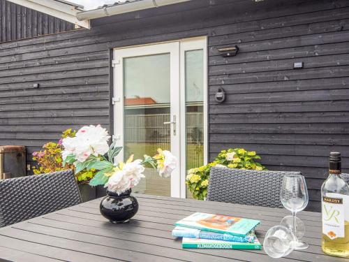 a wooden table with a vase of flowers on it at Luxury Spa Retreat in Thorsminde - By Traum Ferienwohnungen in Ulfborg