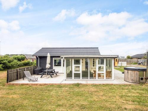 a tiny house with a deck and a patio at Luxury Spa Retreat in Thorsminde - By Traum Ferienwohnungen in Ulfborg
