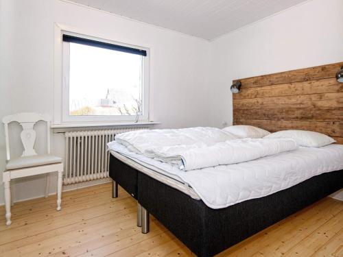 a bedroom with a large bed and a window at Luxury Spa Retreat in Thorsminde - By Traum Ferienwohnungen in Ulfborg