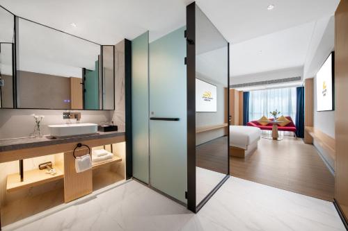 a bathroom with a sink and a mirror at 广州白云国际机场可可Coco酒店-广交会期间展馆穿梭巴士 in Huadu