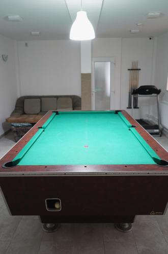 a pool table in a living room at Aquasalis in Câmpulung Moldovenesc