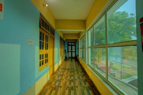 an empty hallway of a school building with windows at HOTEL O Sk GRAND in Sitāpur